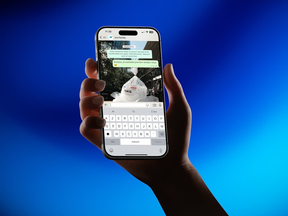 Hand holding smartphone showing messaging app
