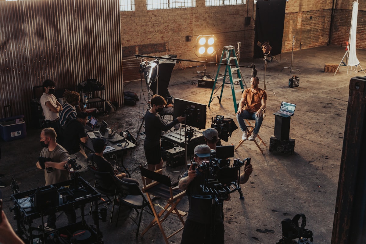 A group of people standing around a camera set up